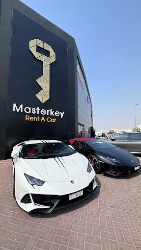 Luxury sports cars parked outside Masterkey Dubai showroom.