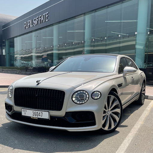 Silver Mercedes-Benz S-Class luxury car parked outside Dubai showroom.